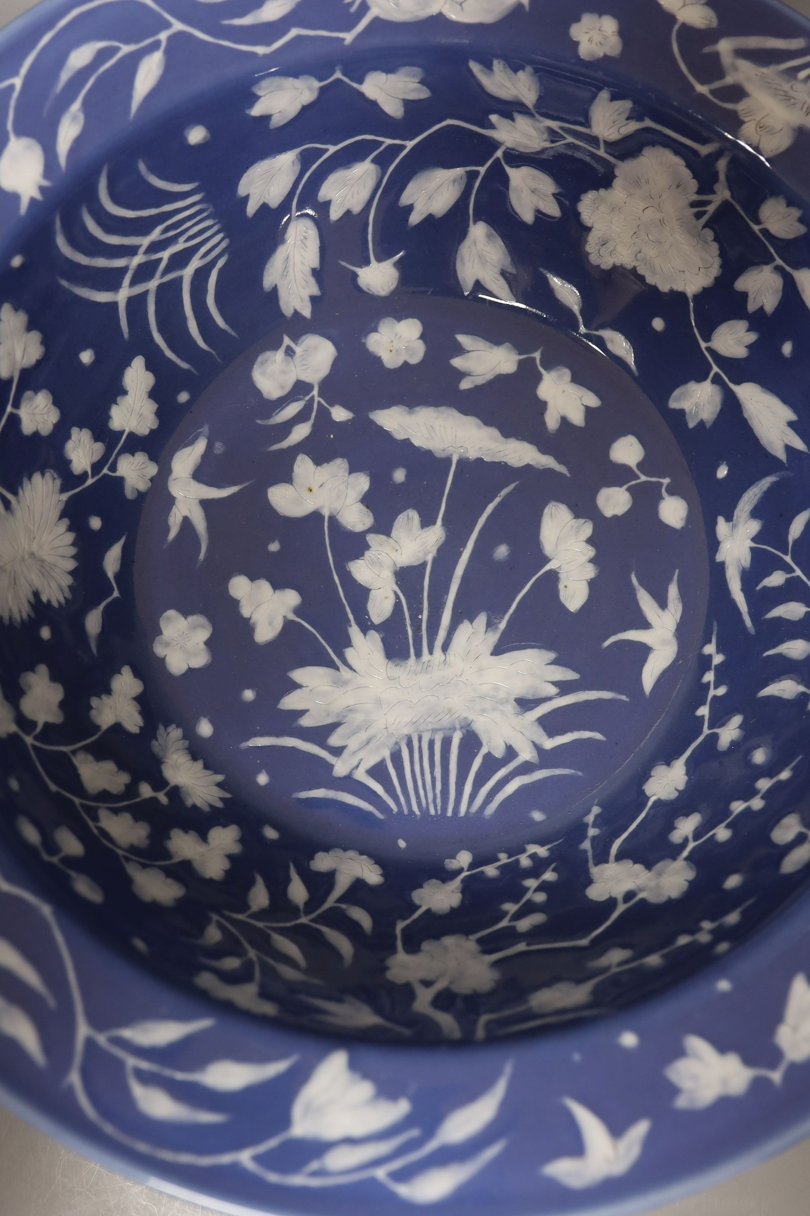 A Chinese export slip decorated blue ground basin, c.1830 - 40cm diameter